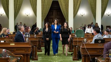 Asm. Soria and Asm. Ortega walk Graciela down Assembly floor aisle