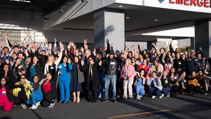 Group photo of grand opening unveiling in front of hospital 